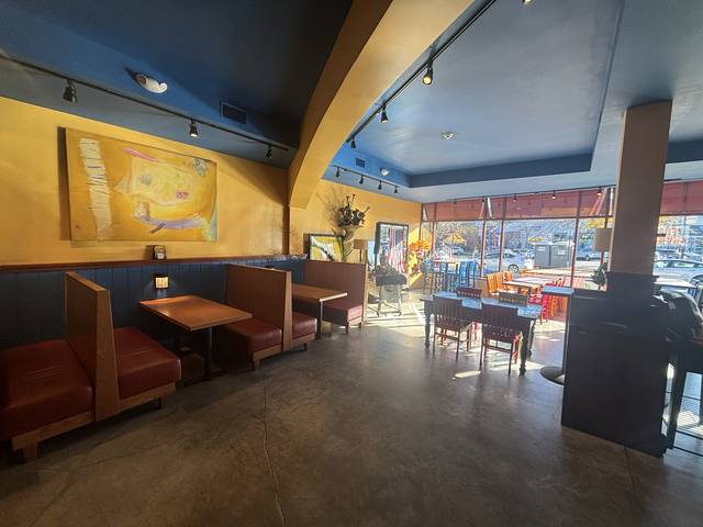 Booths beneath the big yellow painting, looking toward the front windows
